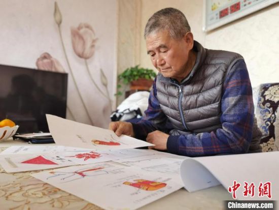 圖為陸鵬飛向記者展示多年帶隊(duì)的手寫筆記。　張婧 攝